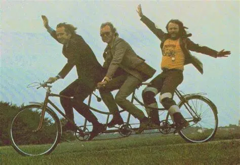 the Goodies - Tim Brooke-Taylor, Graham Garden and Bill Oddie, running down a mild incline on a tandem sometime in the early 70s.